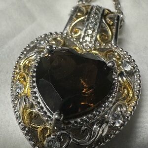 This is a sterling silver filigree heart pendant necklace by STS Karis.